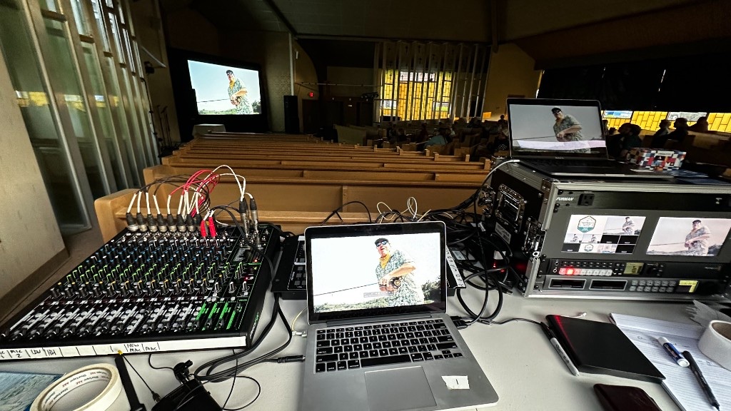 The tech table and the big screen during a film at the 2024 Battenkill festival.