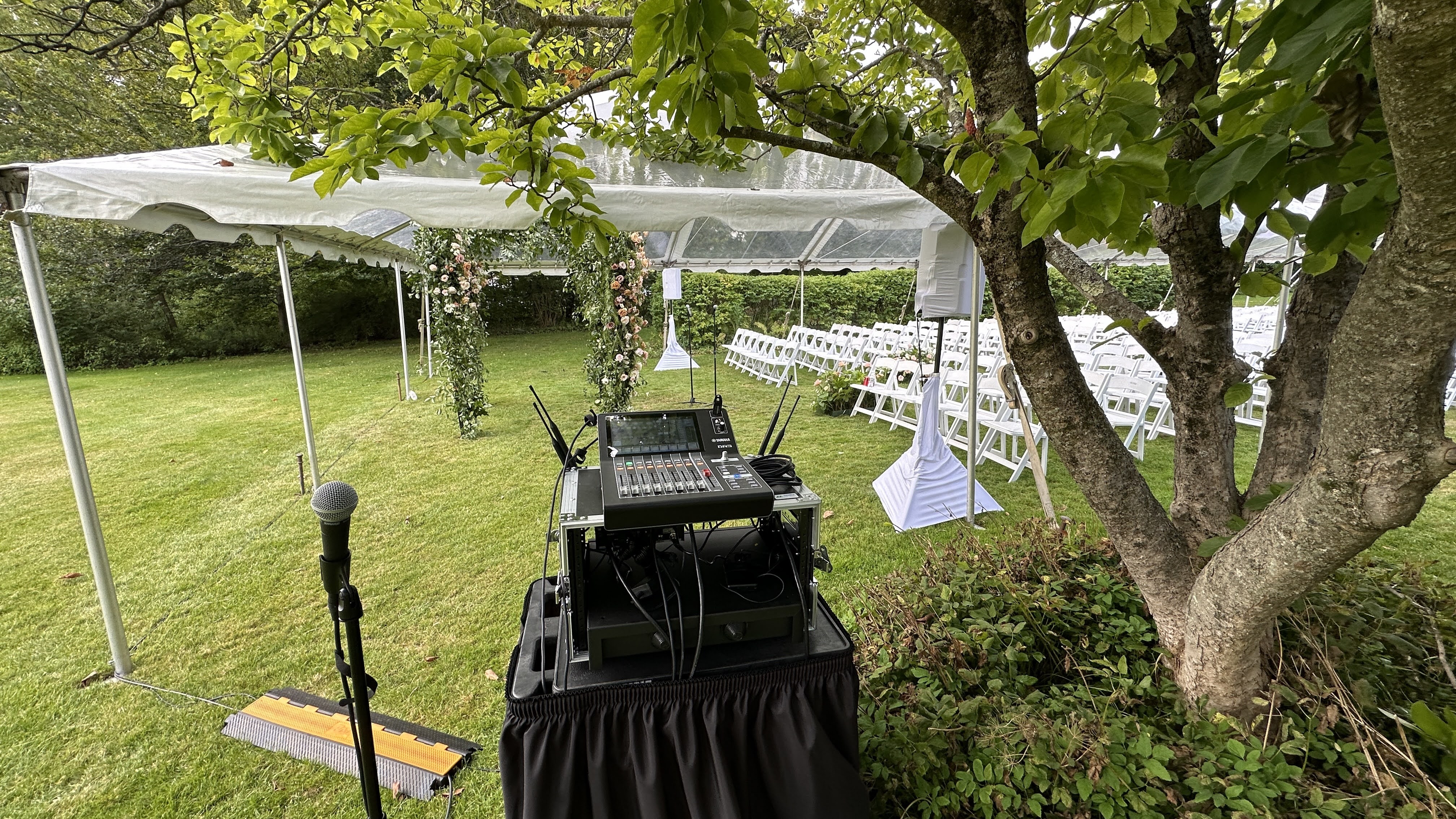 The ceremony setup on the 1811 Lawn, floral arrangements framing the altar.