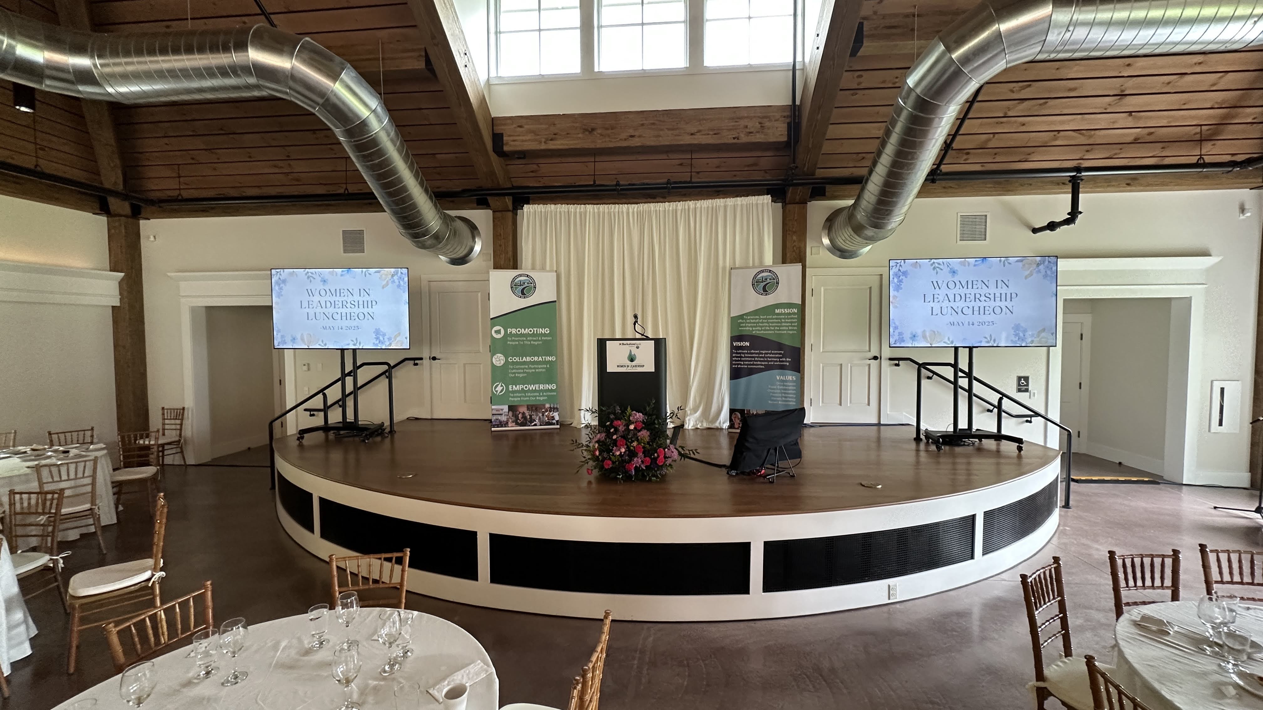A luncheon speaker at Hildene's Lincoln Hall in natural daylight.