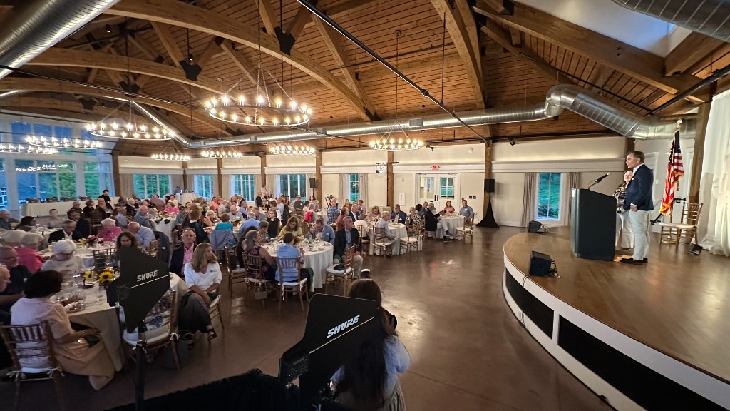Lincoln Hall during the program, with volunteers seated and remarks from the podium at the Hildene Volunteer Appreciation Dinner 2026.