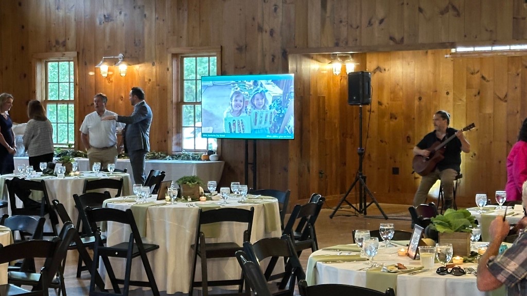 A 75-inch monitor in the Celebration Barn during the 2024 Harvest Moon Gala.